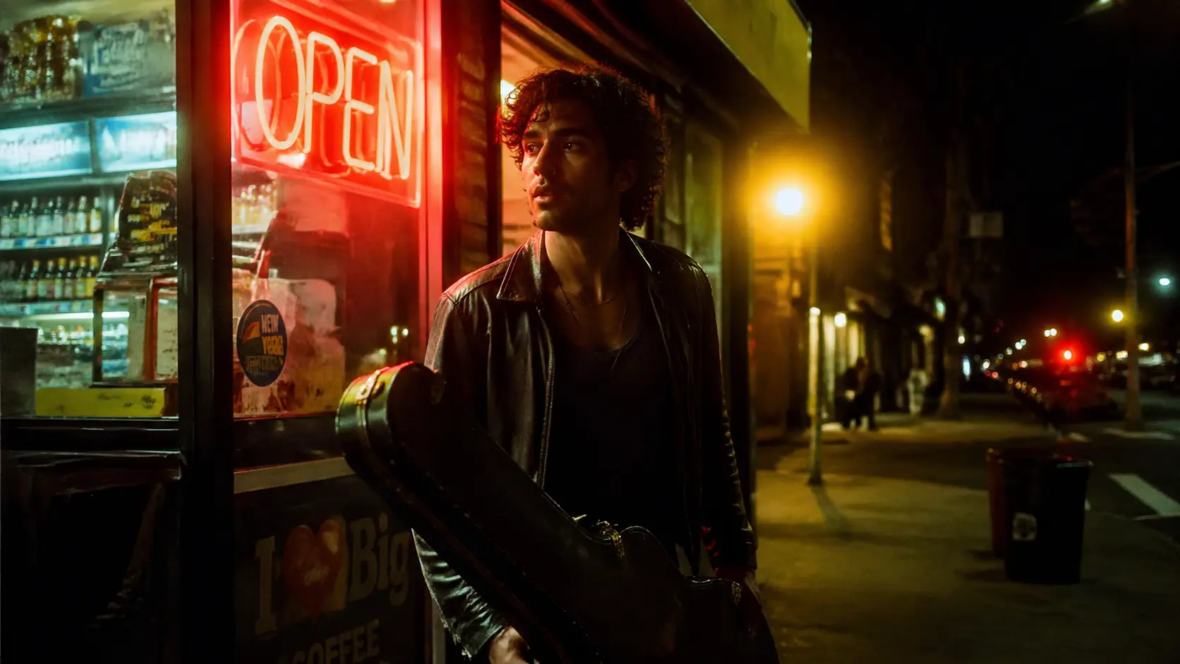Documentary-style night portrait of a young musician stepping out of a downtown bodega